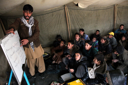 Children of internally displaced families from Afghanistan's southern Helmand province attend a class in the capital, Kabul. Photo: Fardin Waezi / UNAMA
