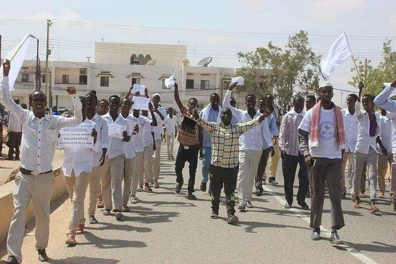 lively street demonstration featuring a group of young men marching together